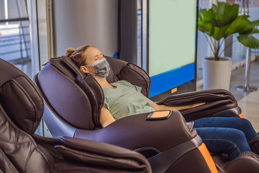 woman on a massage chair with a mask and her eyes closed