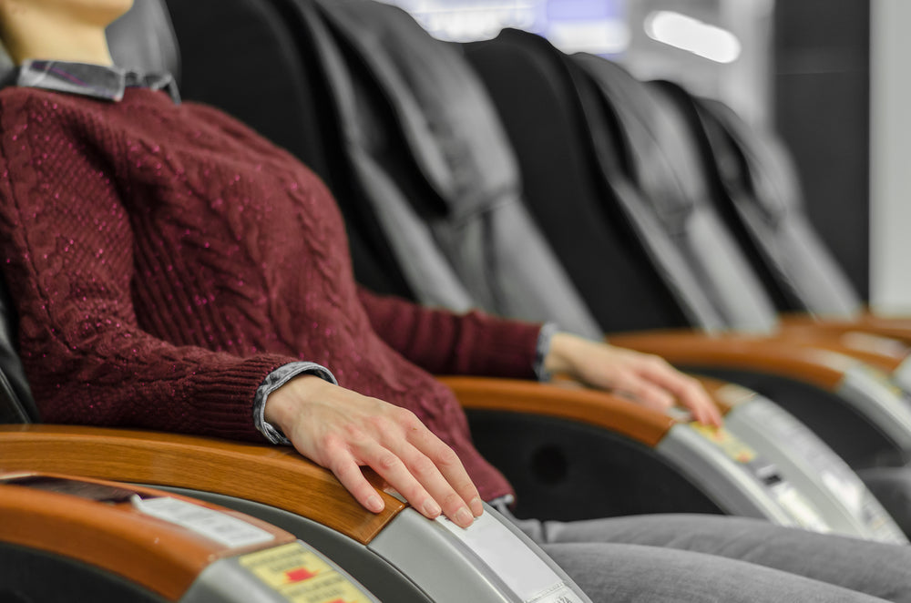 Partial view of a woman sitting on a massage chair